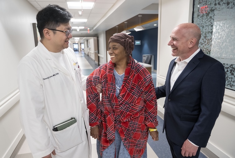 Seung Duk Lee, M.D., Ph.D., Quanda Jordan, and David Bruno, M.D., pose together for a group photo.
