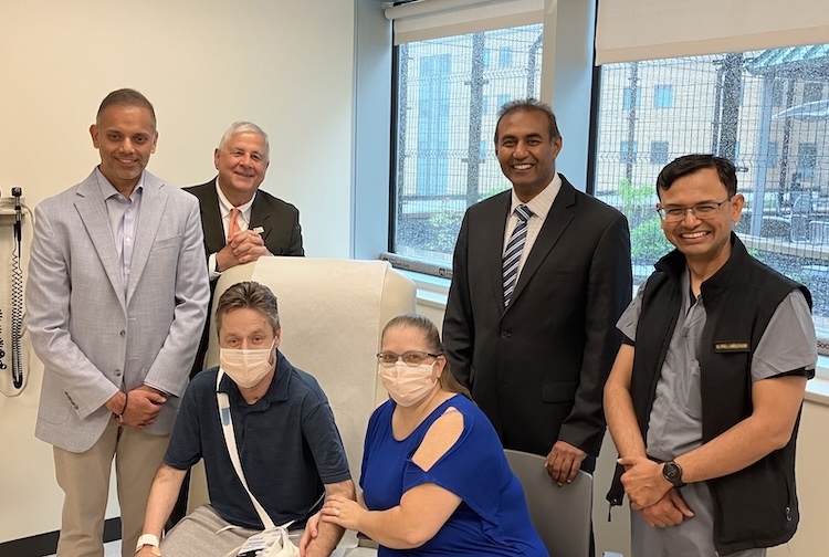 doctors standing with patient and his wife