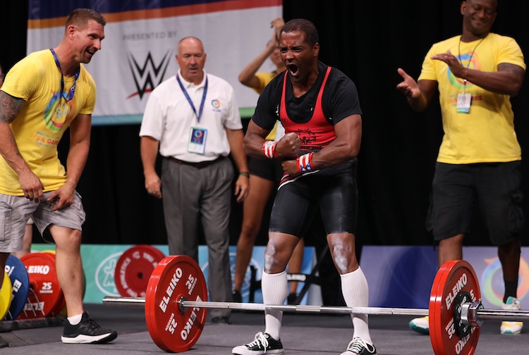 Weight lifter pumped up and yelling happily after finishing a lift