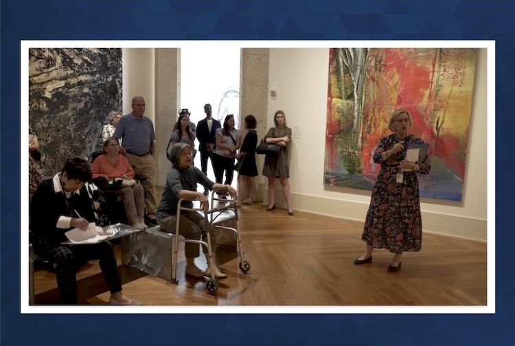 Large group of people looking at art