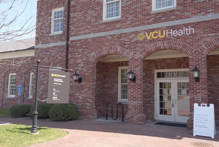 exterior photo of a brick building that has a VCU Health sign