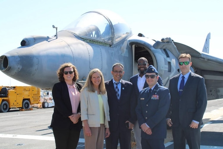 Group of people standing in front of an airplane