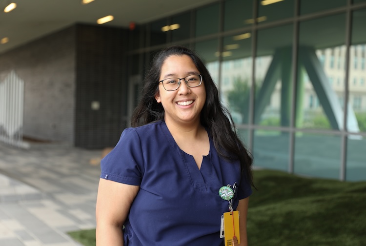 woman in dark purple shirt and glasses