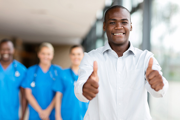 Photo of a man giving a thumb's up gesture