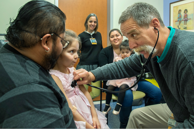 Astrid Cubas-Sanchez with her parents and doctor